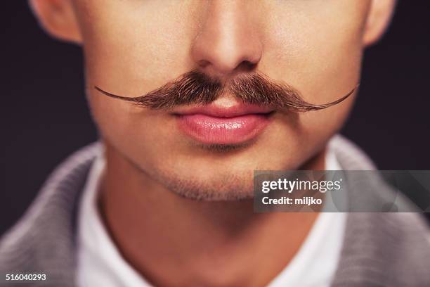 mann mit schnurrbart - mustache stock-fotos und bilder