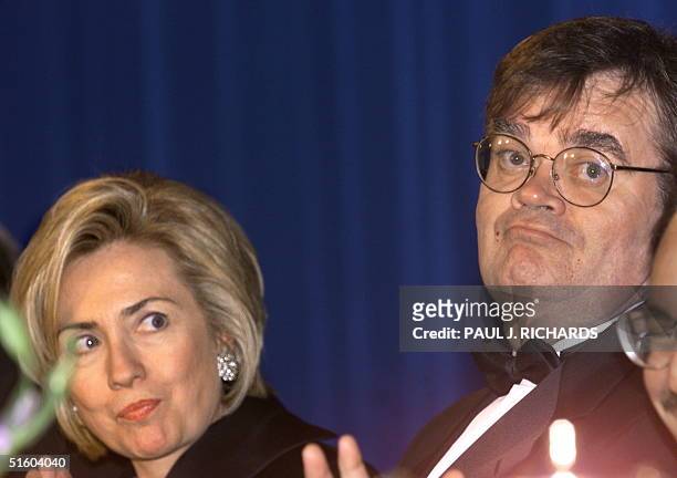 First Lady Hillary Clinton looks towards featured entertainer Garrison Keillor at the Radio & TV Correspondents Annual Dinner 18 March 1999 at the...