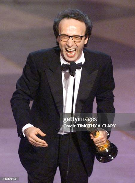 Italian director and actor Roberto Benigni holds his Oscar after winning for Best Performance by an Actor in a Leading Role for his part in the movie...