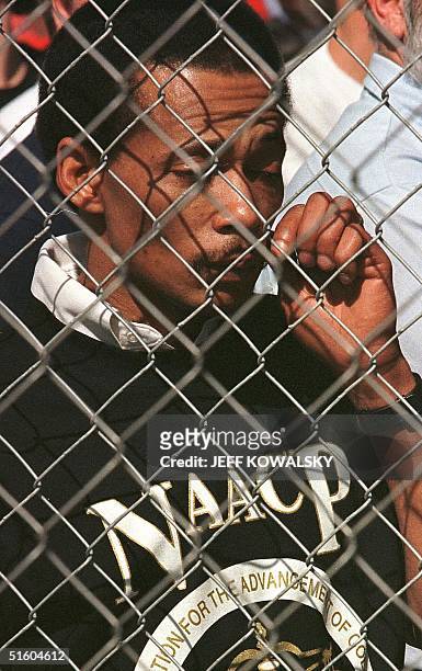 Darrell Nichols, president of Northwest Ohio NAACP, wipes a tear from his eye during a rally of the Ku Klux Klan 20 March 1999 in Defiance, Ohio....
