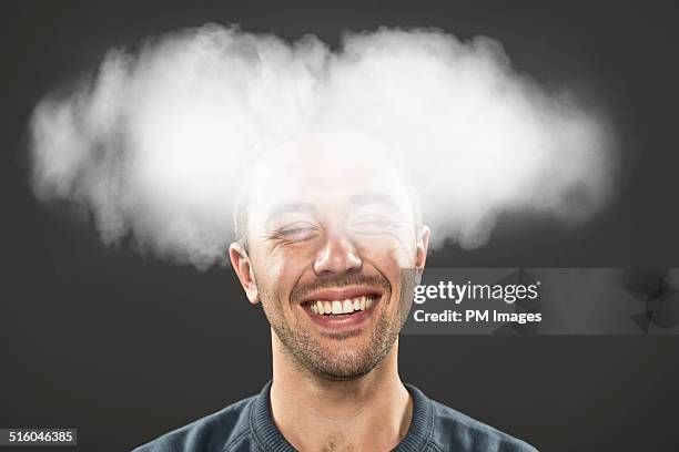 smiling man with head in cloud - estar-en-las-nubes fotografías e imágenes de stock