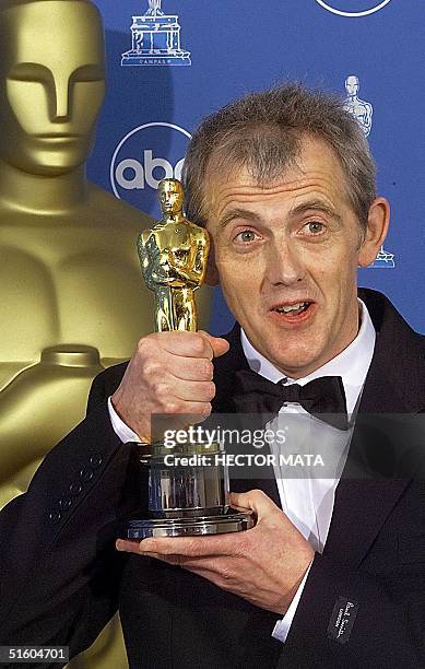 Stephen Warbeck, winner for Best Music, Original Musical or Comedy Score for "Shakespeare In Love", poses for photographers with his Oscar 21 March...
