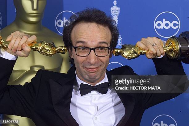 Double Oscar winner for Best Foreign Film and Best Actor Roberto Benigni poses for photographers 21 March, 1999 at the Dorothy Chandler Pavilion in...