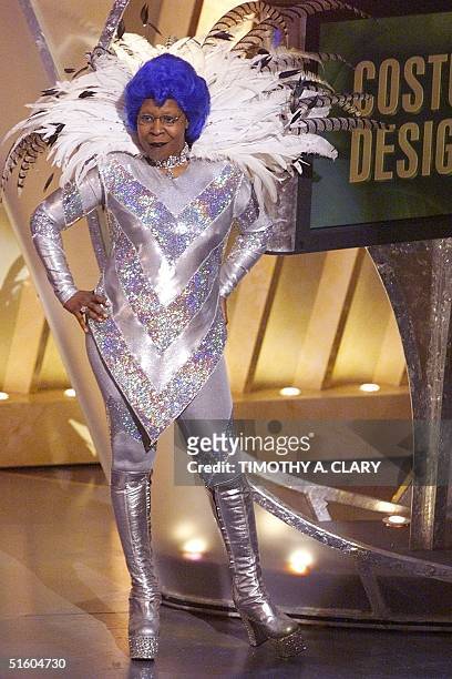 Oscars host Whoopi Goldberg shows off one of the many costumes she wore during the 71st Academy Awards at the Dorothy Chandler Pavilion on March 21,...