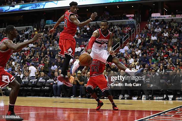 John Wall of the Washington Wizards passes the ball in front of Jimmy Butler of the Chicago Bulls in the second half of their 117-96 win at Verizon...