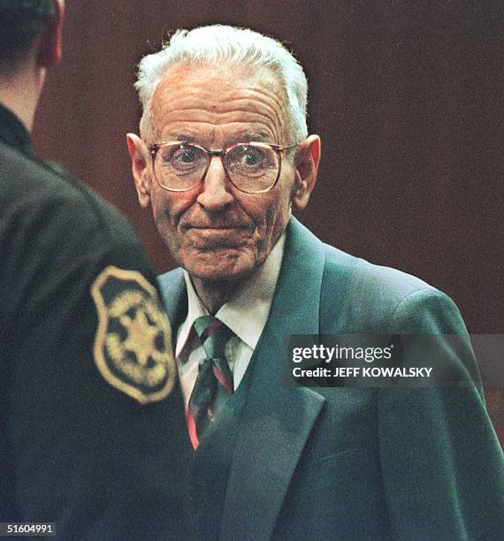 Dr. Jack Kevorkian grimaces after he was convicted of second degree murder in Oakland County Circuit Court 26 March 1999, for giving Thomas Youk, a...