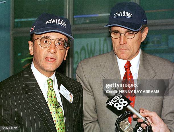 New York Stock Exchange Chairman Richard Grasso and New York City Mayor Rudy Giuliani wear "Dow 10,000" hats. They answered questions after the Dow...