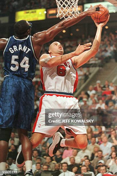 Orlando Magic's Horace Grant blocks a shot by Detroit Piston Bison Dele during the first quarter in Auburn Hills, Michigan, 03 April 1999. AFP...