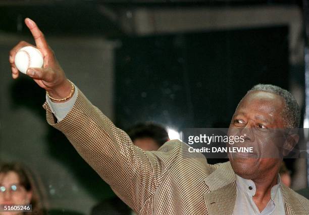 Baseball's home run record holder, player Hank Aaron acknowledges the crowd as he is introduced before throwing out the first pitch of the game...