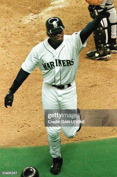 Seattle Mariners Ken Griffey Jr. Salutes Hank Aaron, who is sitting above the field in a press box, after hitting his 351st home run of his career in...