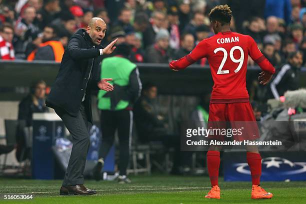 Josep Guardiola, head coach of Muenchen gives intsructions to his player Kingsley Coman during the UEFA Champions League Round of 16 Second Leg match...