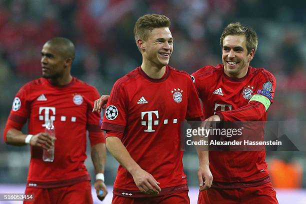 Philipp Lahm team captain of Muenchen celebrates victory with his team mate Joshua Kimmich after winning the UEFA Champions League Round of 16 Second...