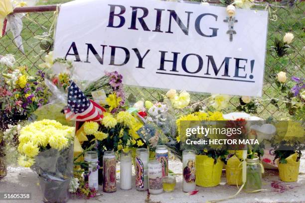 Sign is displayed on the fence of US Army Sargent Andrew Ramirez family's home 08 April 1999 in Los Angeles. Cypriot Parliment Speaker Spyros...