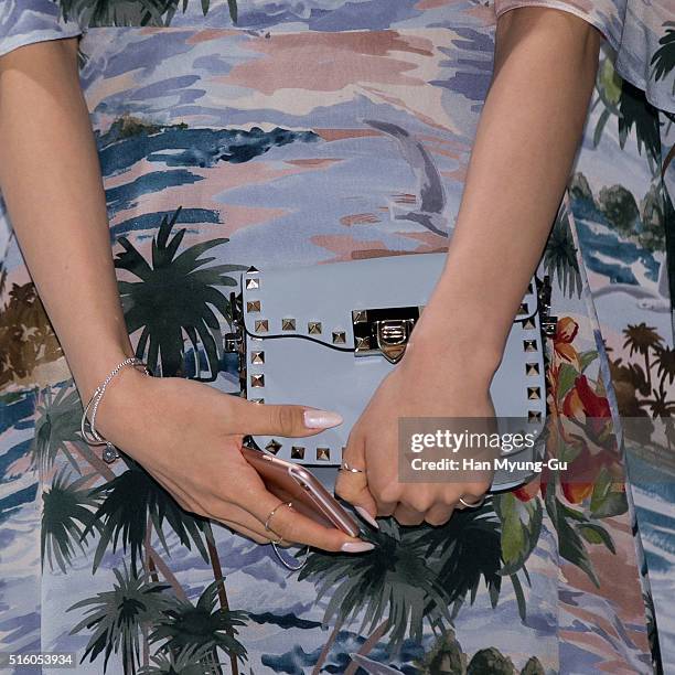Tiffany, bag detail, of South Korean girl group Girls' Generation attends the photocall for "VALENTINO" Hawaiian Couture Capsule Collection at...