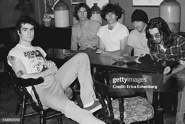 Hardcore punk band Black Flag, group portrait, at the Oporto pub, Holborn, London, United Kingdom, 1983. L-R Henry Rollins, Greg Ginn, Bill...