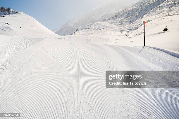just groomed ski slope in andermatt, canton uri, switzerland - skipiste stockfoto's en -beelden