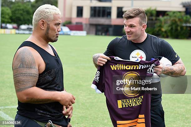 Josh McGuire of the Broncos presents UFC fighter Mark Hunt with a jersey during a UFC photocall on March 17, 2016 in Brisbane, Australia.