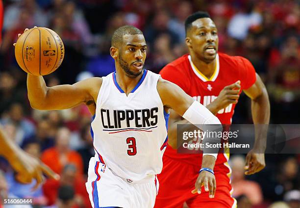Chris Paul of the Los Angeles Clippers takes the basketball down the court in front of Dwight Howard of the Houston Rockets during their game at the...