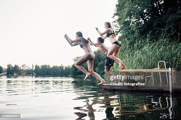 carefree summer day: teenagers jumping into a lake - 17 loch stock pictures, royalty-free photos & images