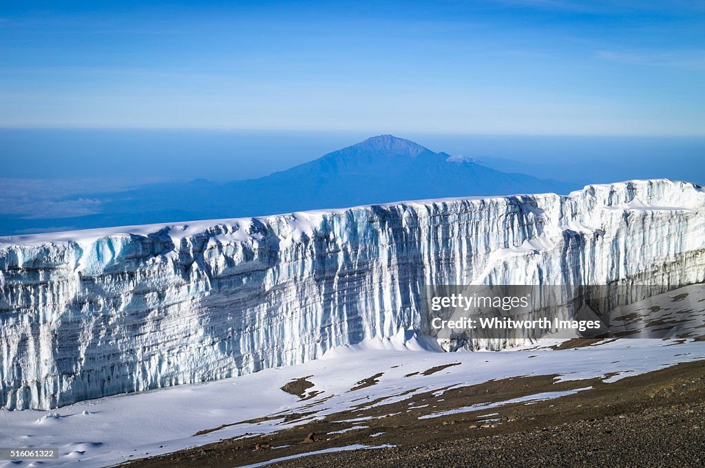 Glacier wall near Mt Kilimanjaro summit, Tanzania, and Mt Meru in background