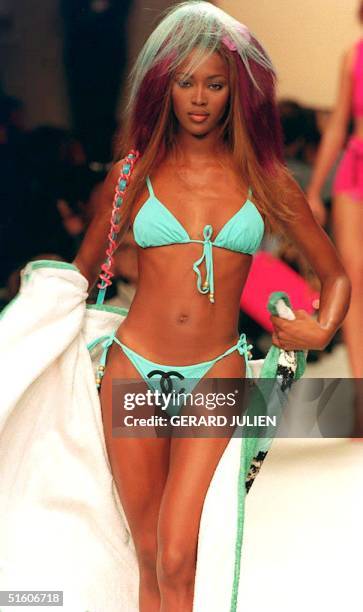 Top model Naomi Campbell presents 14 October 1993, in Paris, France, a turquoise two-pieces bathing suit and a white bathrobe by Karl Lagerfield...
