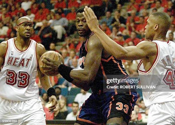 New York Knicks' Patrick Ewing works between Alonzo Mourning and P.J. Brown of the Miami Heat 08 May 1999 during game one of their 1st round play-off...