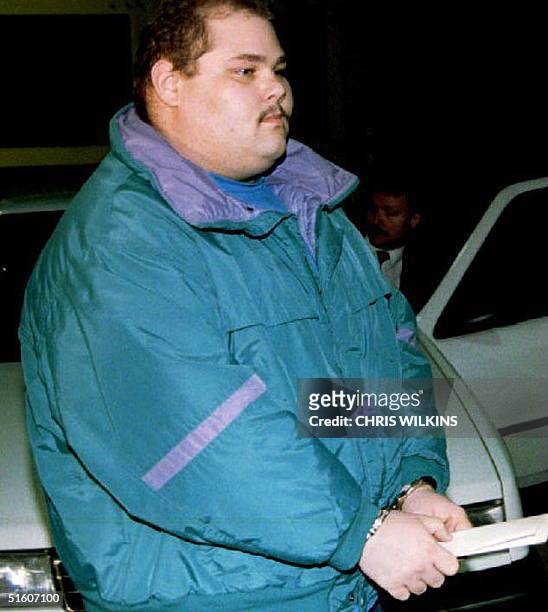 Shawn Eric Eckardt, bodyguard of figure skater Tonya Harding, walks handcuffed into jail after being arrested and charged with conspiracy in the...