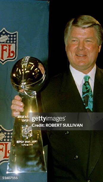 Dallas Cowboys Head Coach Jimmy Johnson poses with the Vince Lombardi Trophy, 28 January 1994, which will go to the winner of the Super Bowl XXVIII....