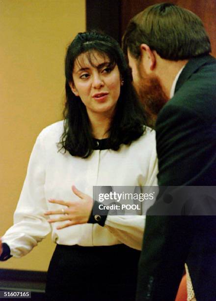 Lorena Bobbitt confers with her attorney, James Lowe, after the jury asked two questions as they deliberated in her malicious wounding trial at the...