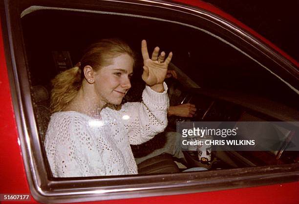 Figure skater Tonya Harding waves to cameramen through her car window 15 January 1994 as she and ex-husband Jeff Gillooly drive up to her rural...