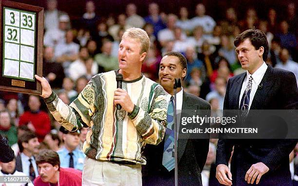 Former Boston Celtics players Larry Bird and Dennis Johnson present Kevin McHale a with a replica of the banner he later raised into the rafters of...