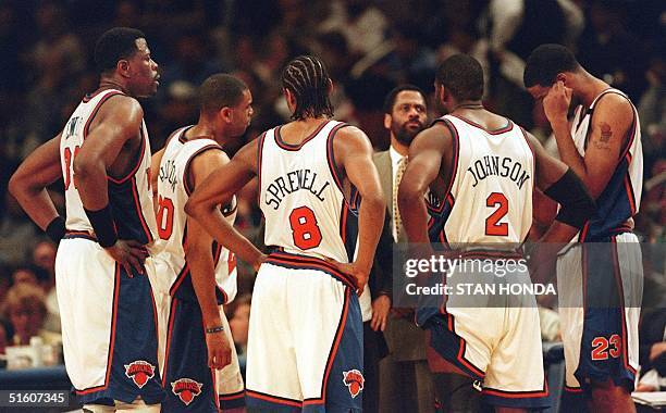 Nearly defeated New York Knicks team meets during a time-out late in the fourth quarter of the fourth game of their Eastern Conference first round...