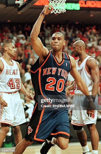 Allan Houston of the New York Knicks celebrates his game-winning shot in front of P.J. Brown and Alonzo Mourning of the Miami Heat16 May 1999 during...