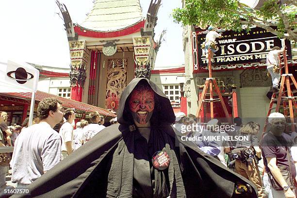 Mickie Lujan from North Hollywood dressed as Darth Maul, the evil Sith lord from "Star Wars Episode 1: The Phantom Menace," poses outside the Mann's...