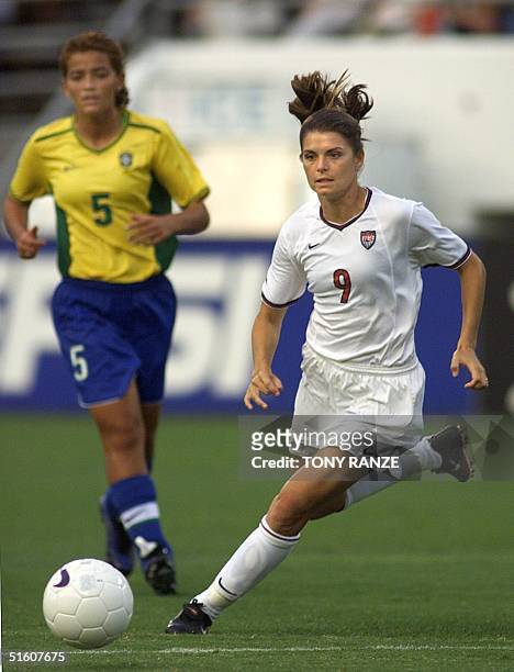 United States Women's National Team forward Mia Hamm drives to the goal with Brazil Women's National Team midfielder Cidinha in pursuit during the...