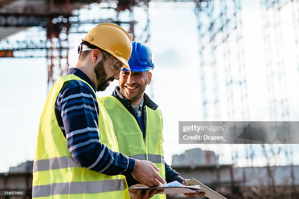 Engineer and construction site manager dealing with next construction phase