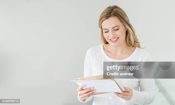 woman at home getting the mail - reading mail stock pictures, royalty-free photos & images