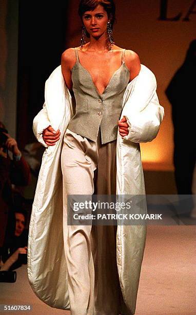 Model presents a doudoune in white-silk taffeta, over a waistcoat in silver-basket weave organze and pants, in a grey-stretch silk crepe by the...