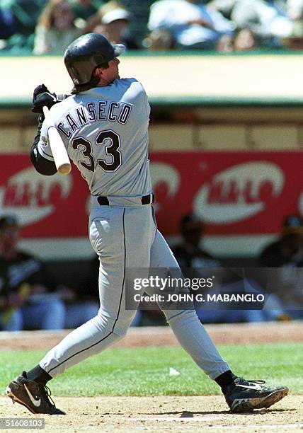 The Tampa Bay Devil Rays' Jose Canseco launches a three-run homerun against the Oakland Athletics 02 June in Oakland, California. Canseco also hit an...