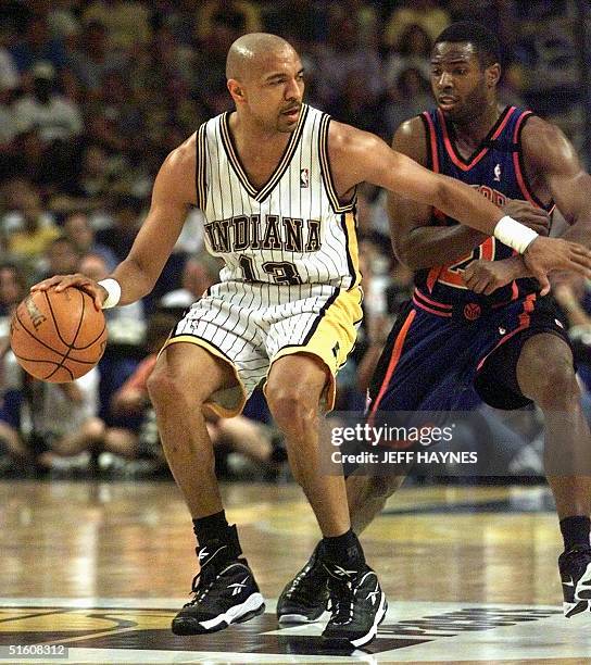 Mark Jackson of the Indiana Pacers tries to keep Charlie Ward of the New York Knicks aways from the basketball 09 June during the first half of game...