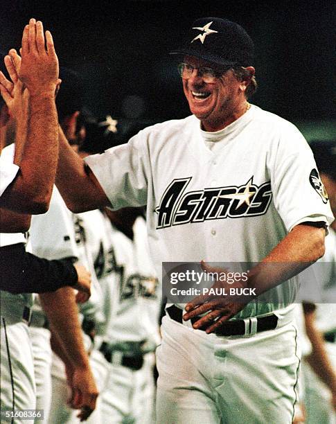 In this 06 April 1999 file photo, Houston Astros manager Larry Dierker high-fives teammates during player introductions on opening day at the...