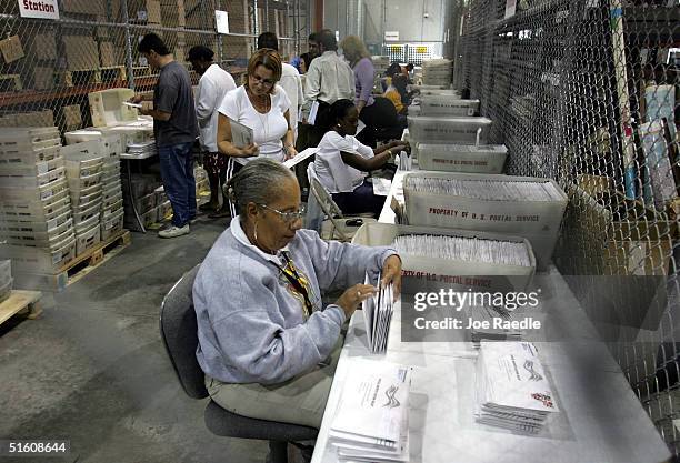 Carol Mitchell sorts absentee ballots that have arrived at the Miami-Dade Elections headquarters October 28, 2004 in Miami, Florida. Since early...