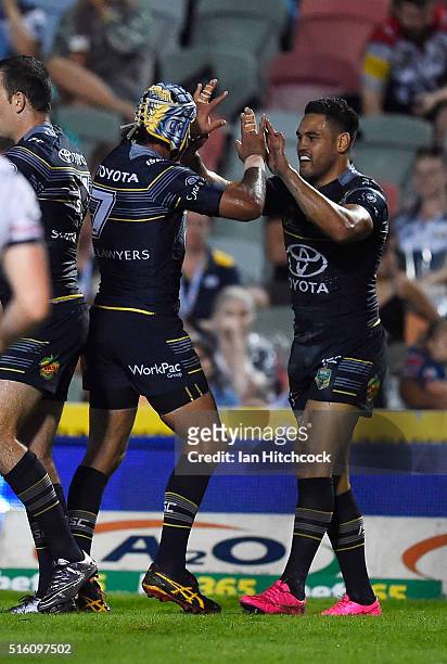 Antonio Winterstein of the Cowboys celebrates after scoring a try with Johnathan Thurston of the Cowboys during the round three NRL match between the...