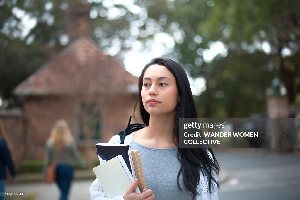 University student on campus carrying books