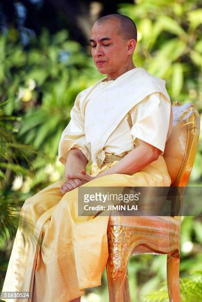 Cambodia's new King Norodom Sihamoni sits on a high platform during a religious ceremony at the Royal Palace in Phnom Penh 29 October 2004....