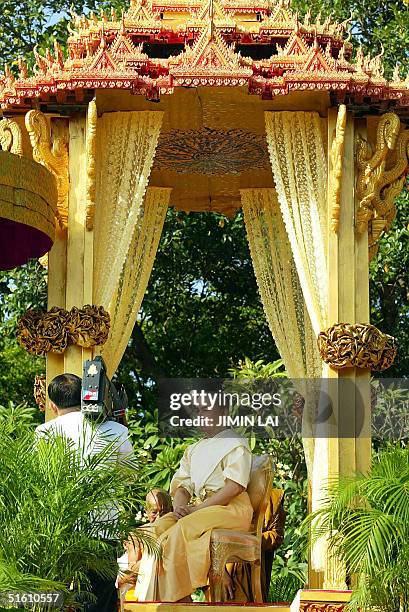 Cambodia's new King Norodom Sihamoni sits in a royal pavilion during a religious ceremony at the Royal Palace in Phnom Penh 29 October 2004....