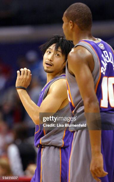 Yuta Tabuse talks to teammate Leandro Barbosa of the Phoenix Suns during a preseason game against the Los Angeles Clippers on October 28, 2004 at...