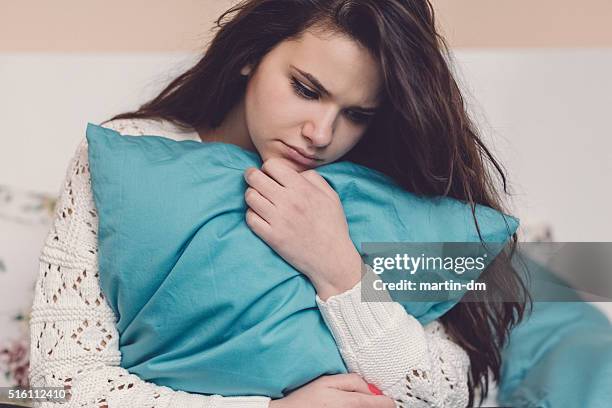 depressed teenage girl in bed - girls period pics stock pictures, royalty-free photos & images