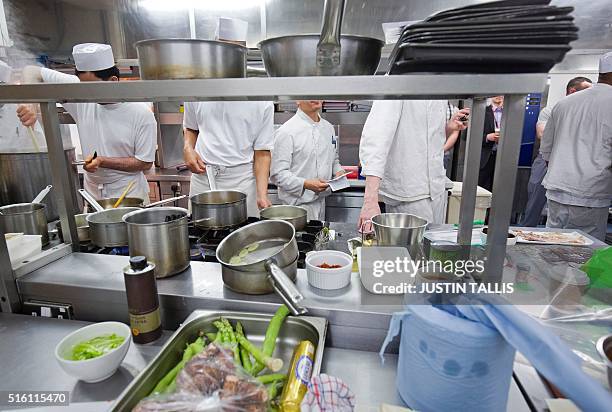 Prisoners work in the kitchen at the Clink Restaurant ahead of the lunch service inside Brixton Prison in south London on March 15, 2016. Accessed...