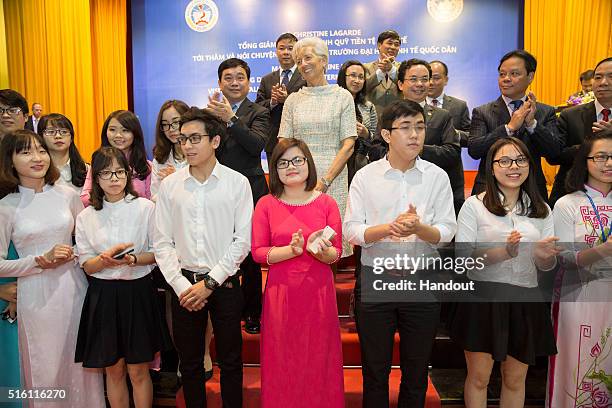 In this handout photo provided by the International Monetary Fund , International Monetary Fund Managing Director Christine Lagarde is joined by...